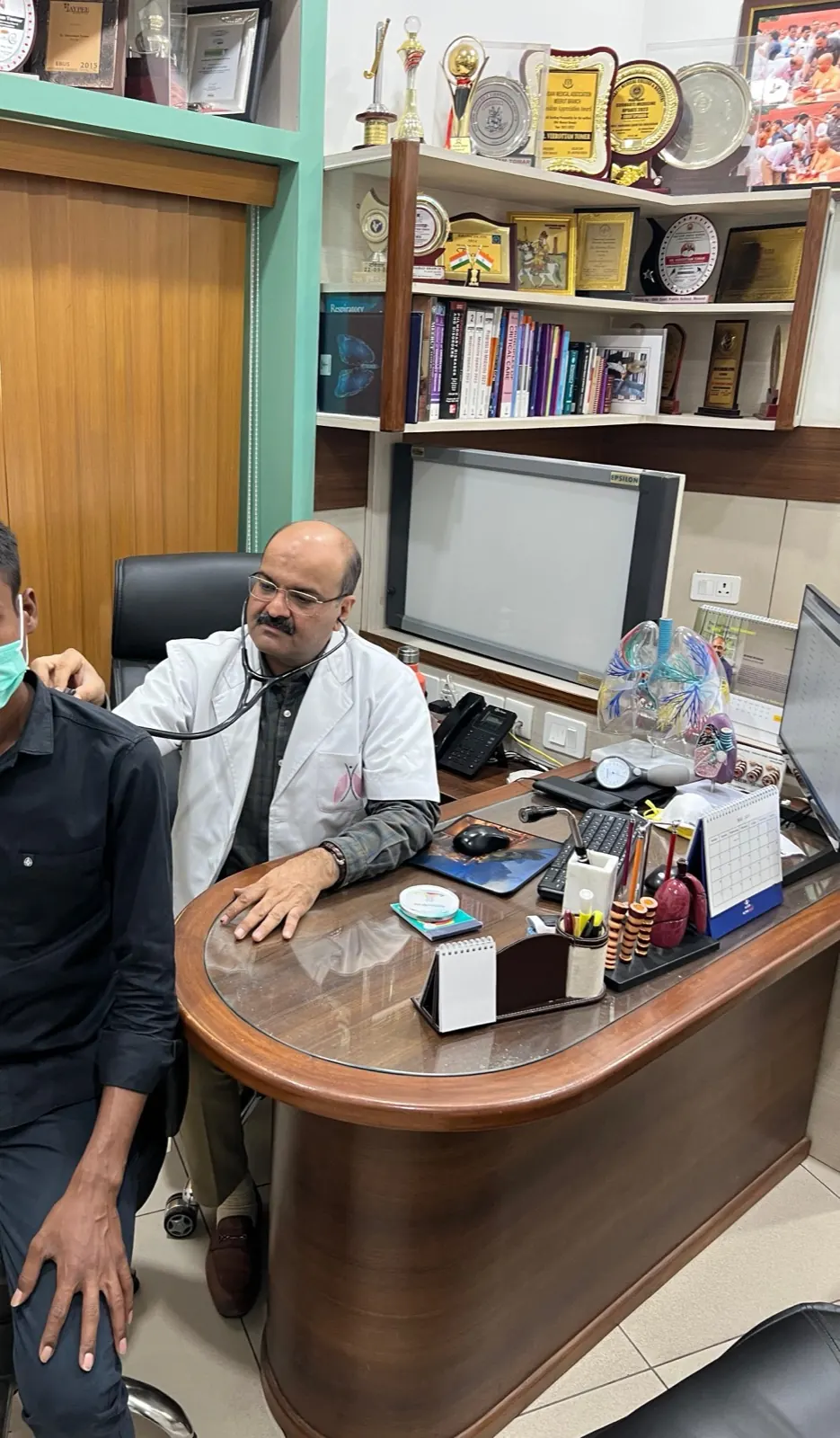 Dr. Tomer at his desk during a consultation